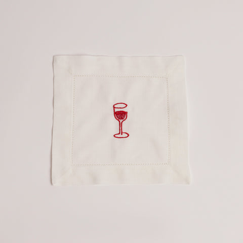 Single white cocktail napkin embroidered with a red wine glass. Single white cocktail napkin embroidered with a red wine glass.