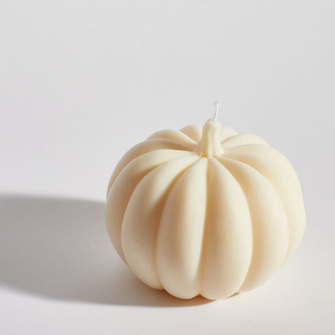 Close-up of Boujie Medium Pumpkin Decorative Candle in classic cream soy wax. Close-up of Boujie Medium Pumpkin Decorative Candle in classic cream soy wax.