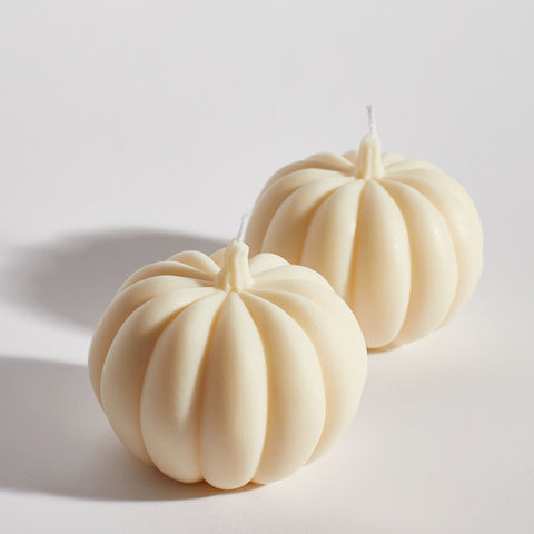 Two Boujie Medium Pumpkin Decorative Candles side by side close up, handmade in soy wax with classic cream finish. Two Boujie Medium Pumpkin Decorative Candles side by side close up, handmade in soy wax with classic cream finish.