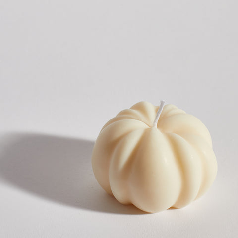 Close-up of Boujie Small Pumpkin Decorative Candle, hand-poured in classic cream soy wax. Close-up of Boujie Small Pumpkin Decorative Candle, hand-poured in classic cream soy wax.