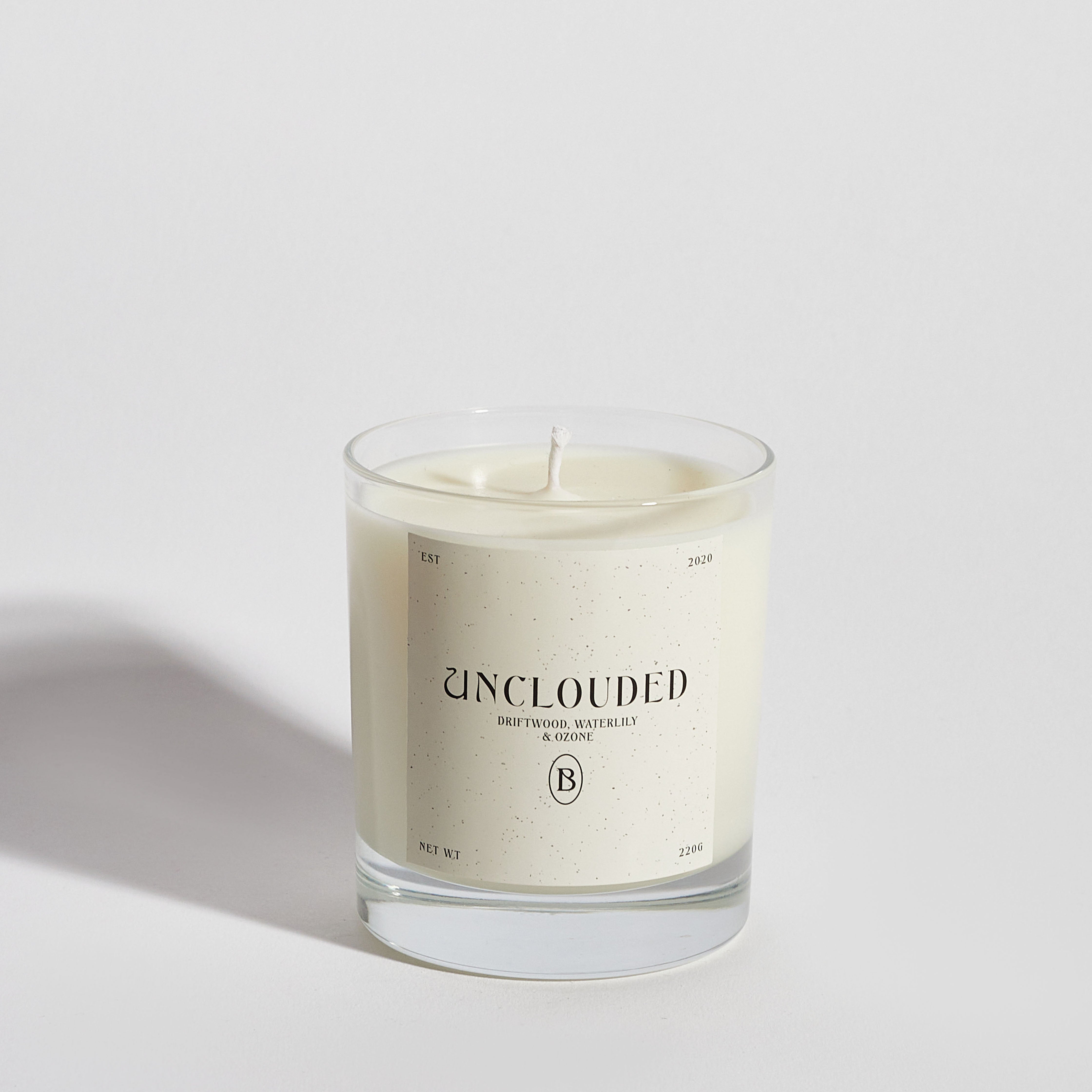 Boujie Unclouded luxury soy wax jar candle, front view, handmade with natural soy wax in a clear glass jar, scented with rock salt and driftwood, styled with coastal-inspired elements. Boujie Unclouded luxury soy wax jar candle, front view, handmade with natural soy wax in a clear glass jar, scented with rock salt and driftwood, styled with coastal-inspired elements.