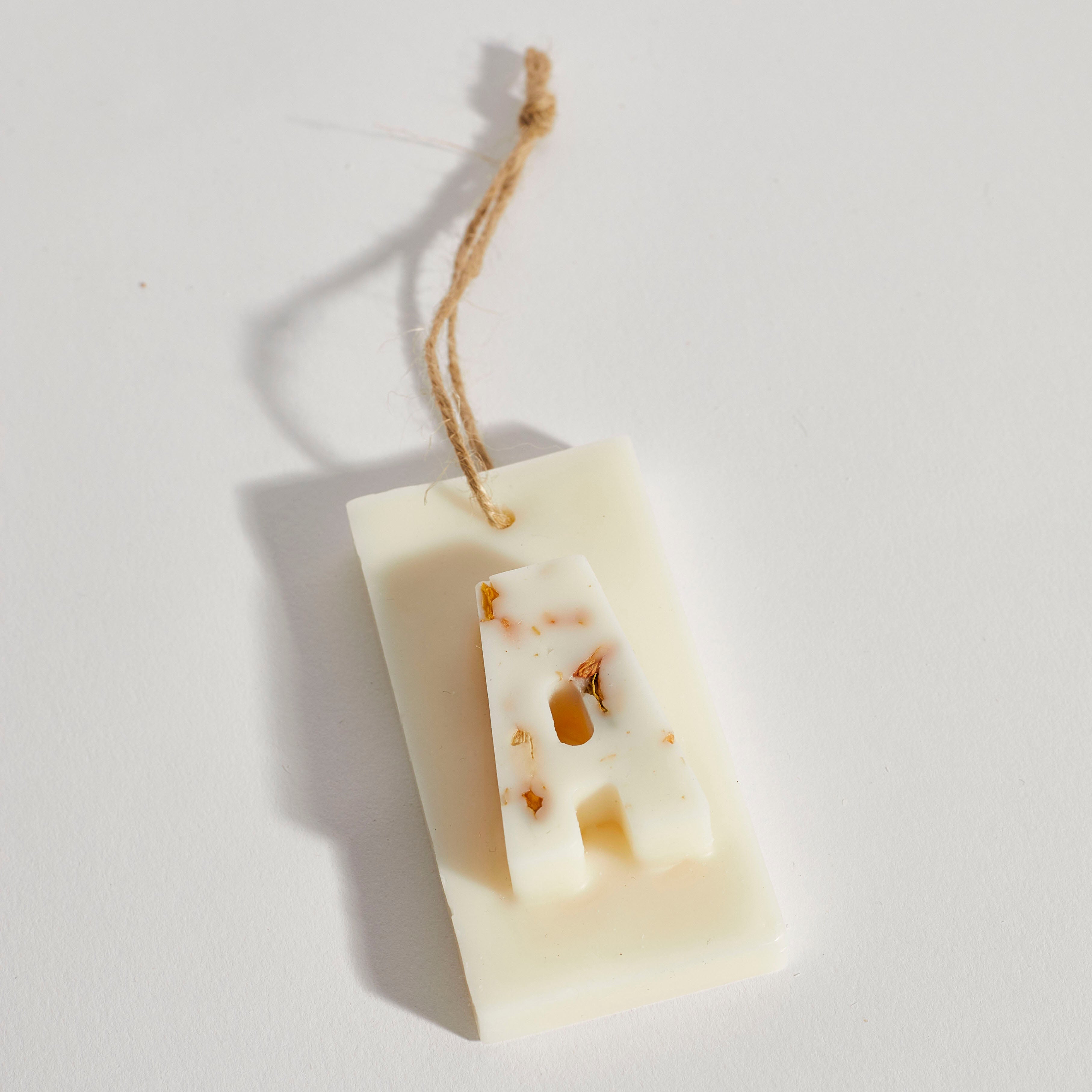 Close-up of personalised scented tree decoration with letter A, handmade eco-friendly soy wax ornament by Boujie. Close-up of personalised scented tree decoration with letter A, handmade eco-friendly soy wax ornament by Boujie.