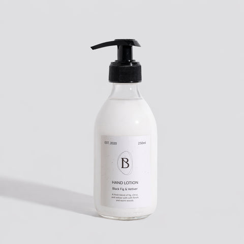 Hand lotion bottle with pump on a light gray background