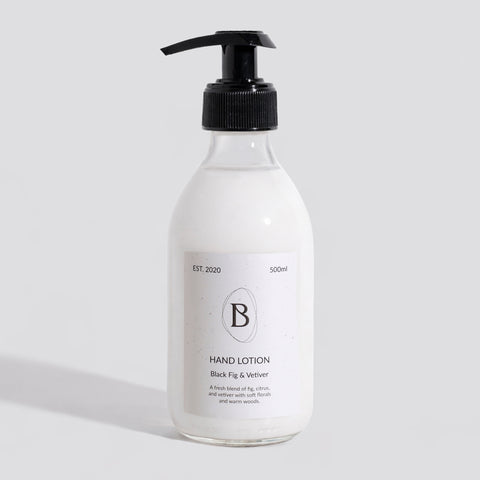 Hand lotion bottle with pump on a light gray background