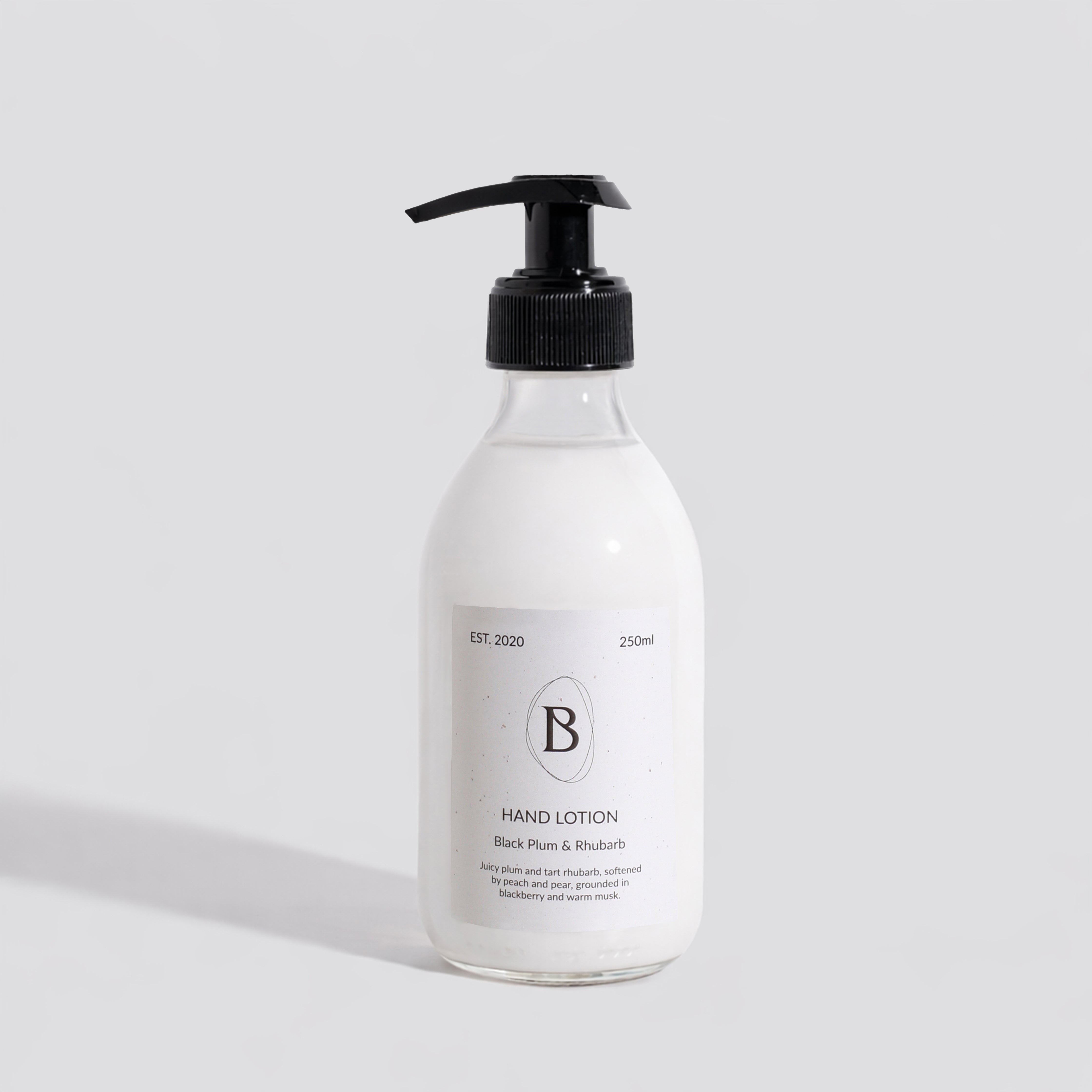 Hand lotion bottle with pump on a light gray background
