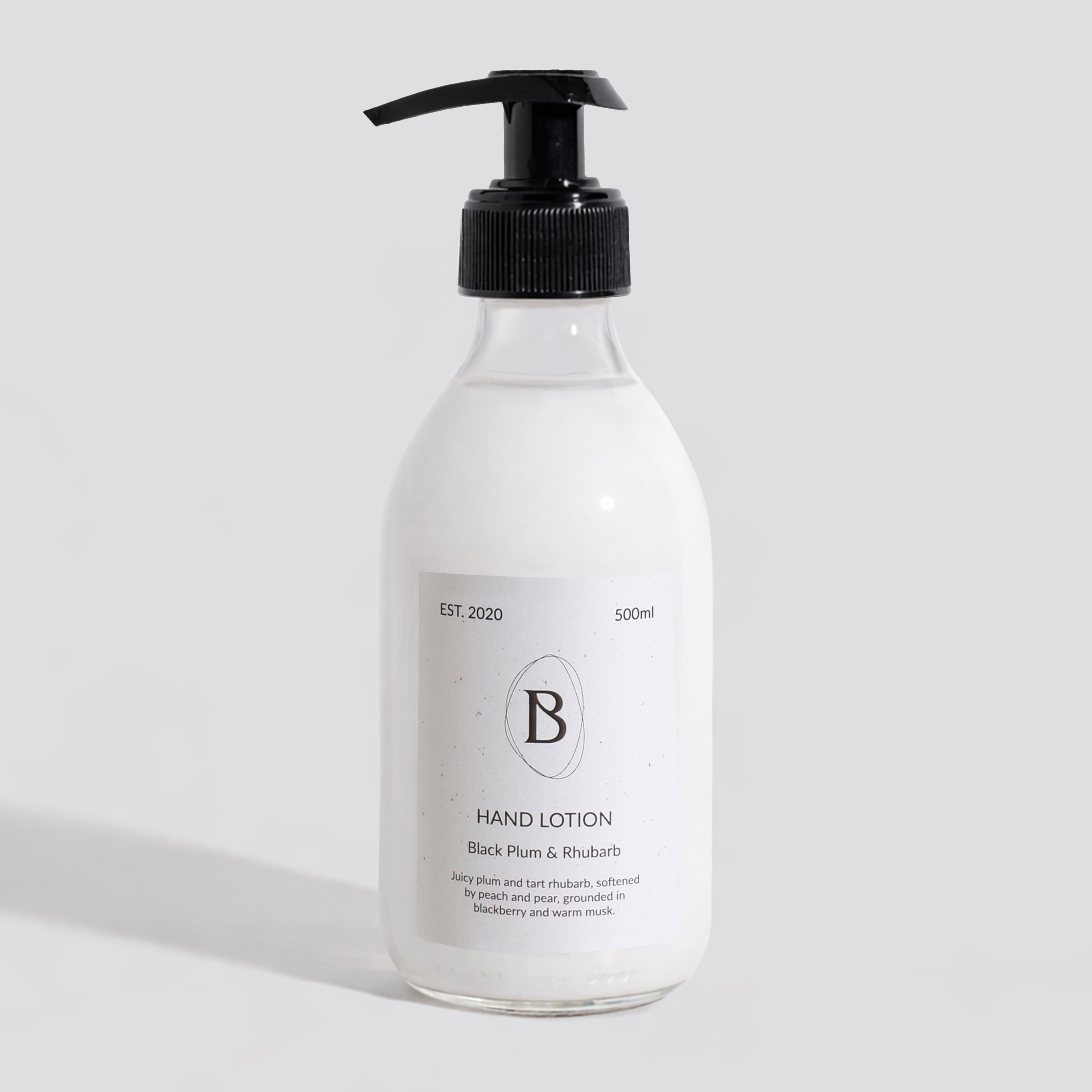 Hand lotion bottle with pump on a light gray background