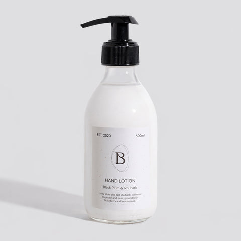 Hand lotion bottle with pump on a light gray background
