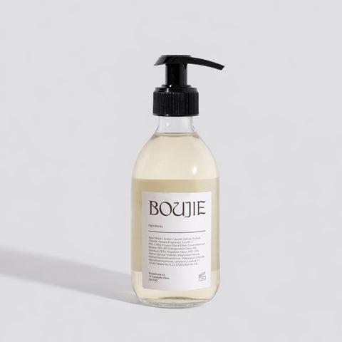 Bottle of Boujie product on a light gray background
