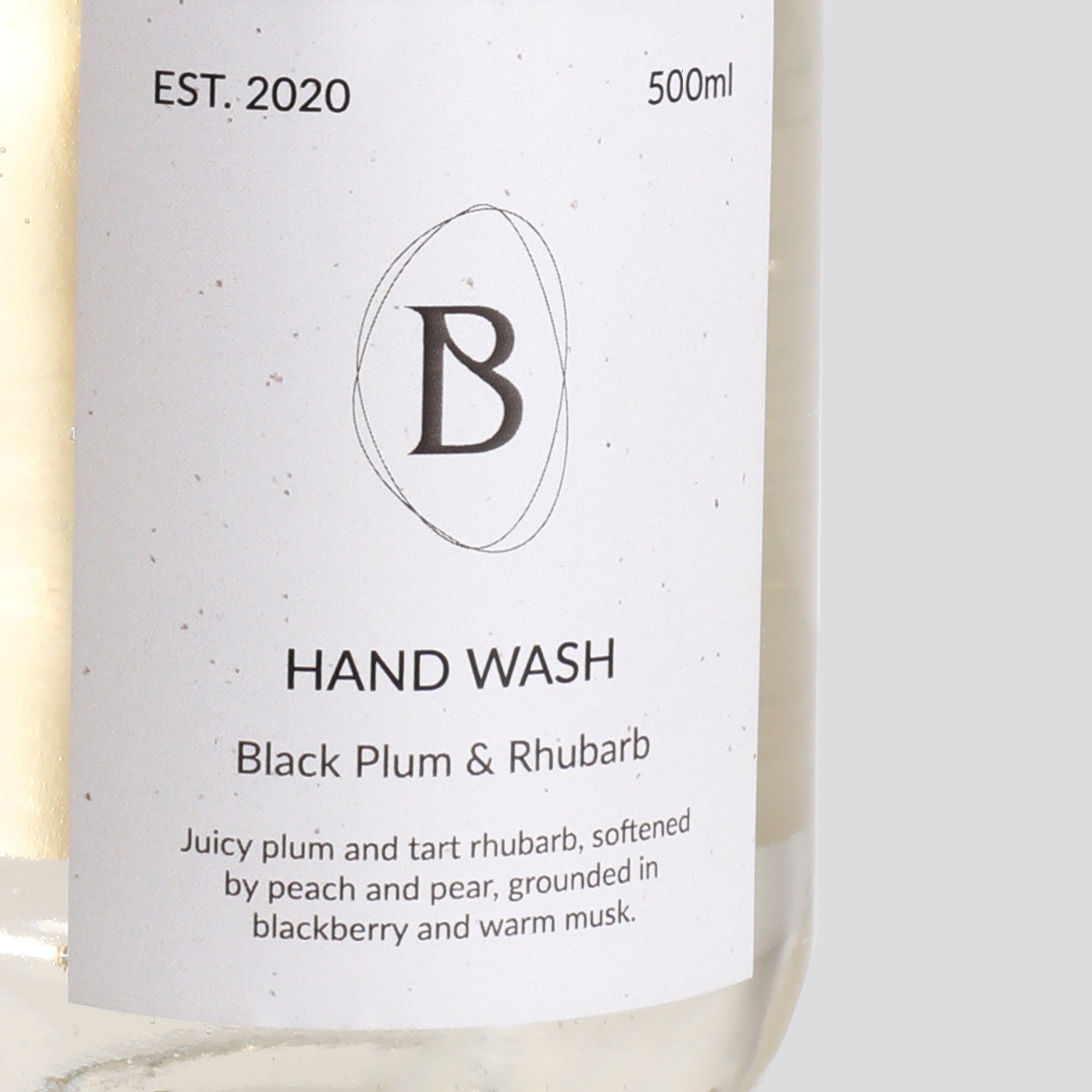Hand wash bottle with label featuring 'B' logo and product details.