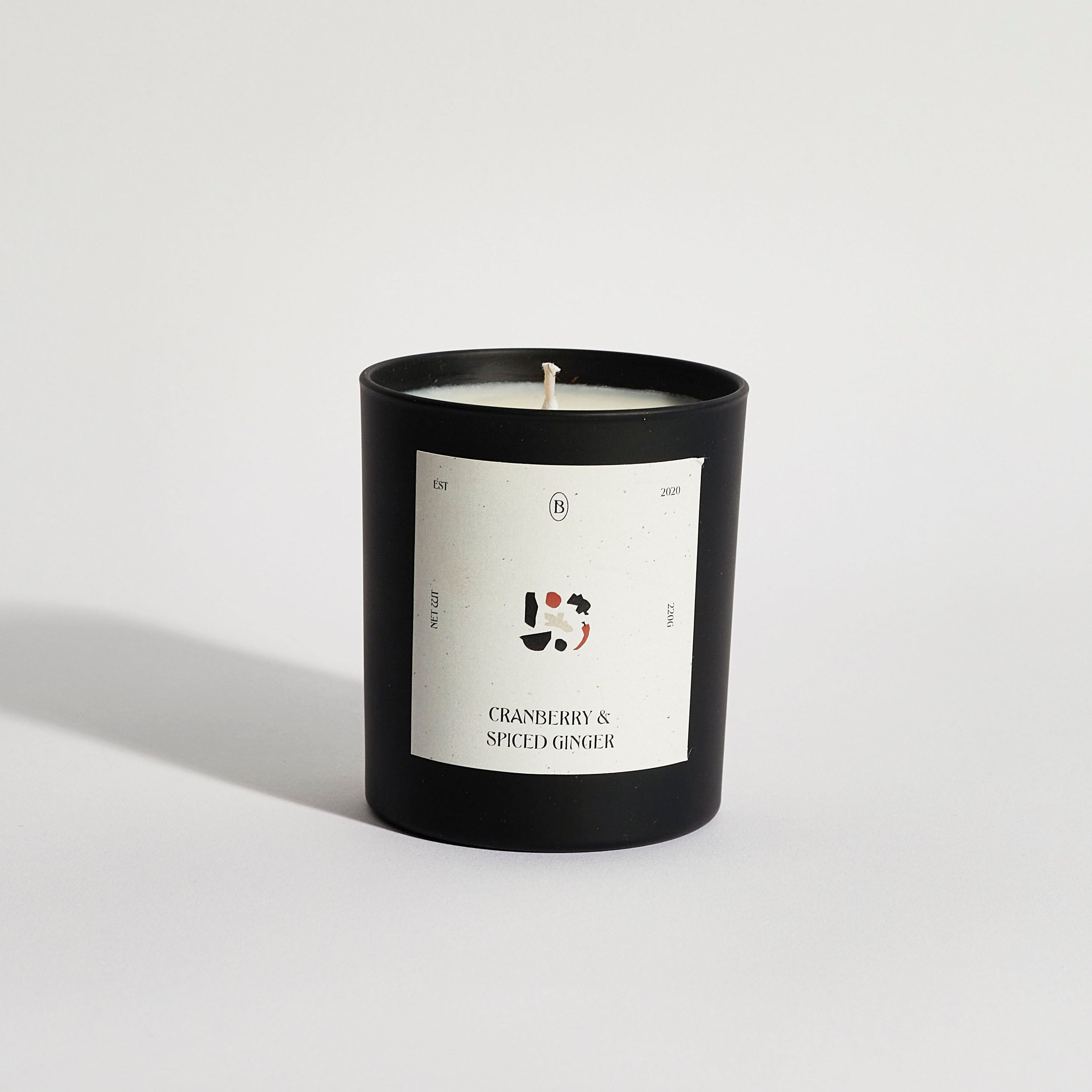 Boujie cranberry and spiced ginger jar candle, handmade with natural soy wax in a black jar – front view.
