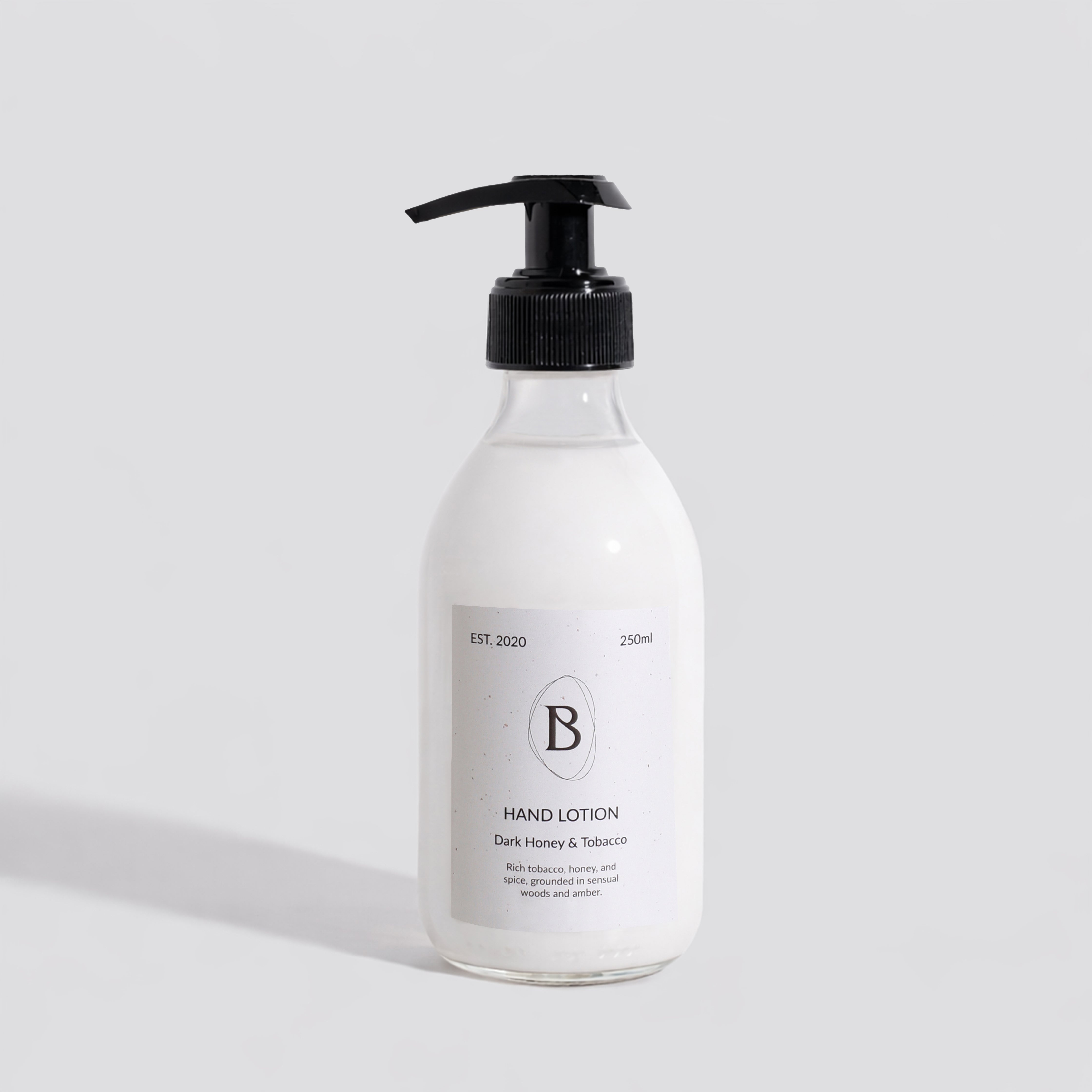 Hand lotion bottle with pump on a light gray background