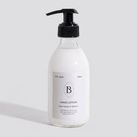 Hand lotion bottle with pump on a light gray background