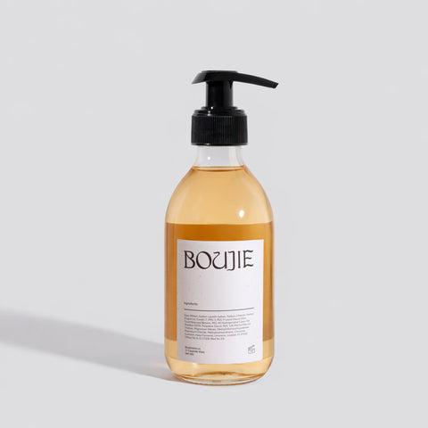 Bottle of Boujie product on a light gray background