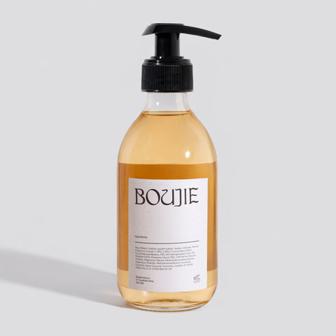 Bottle of Boujie product on a light gray background