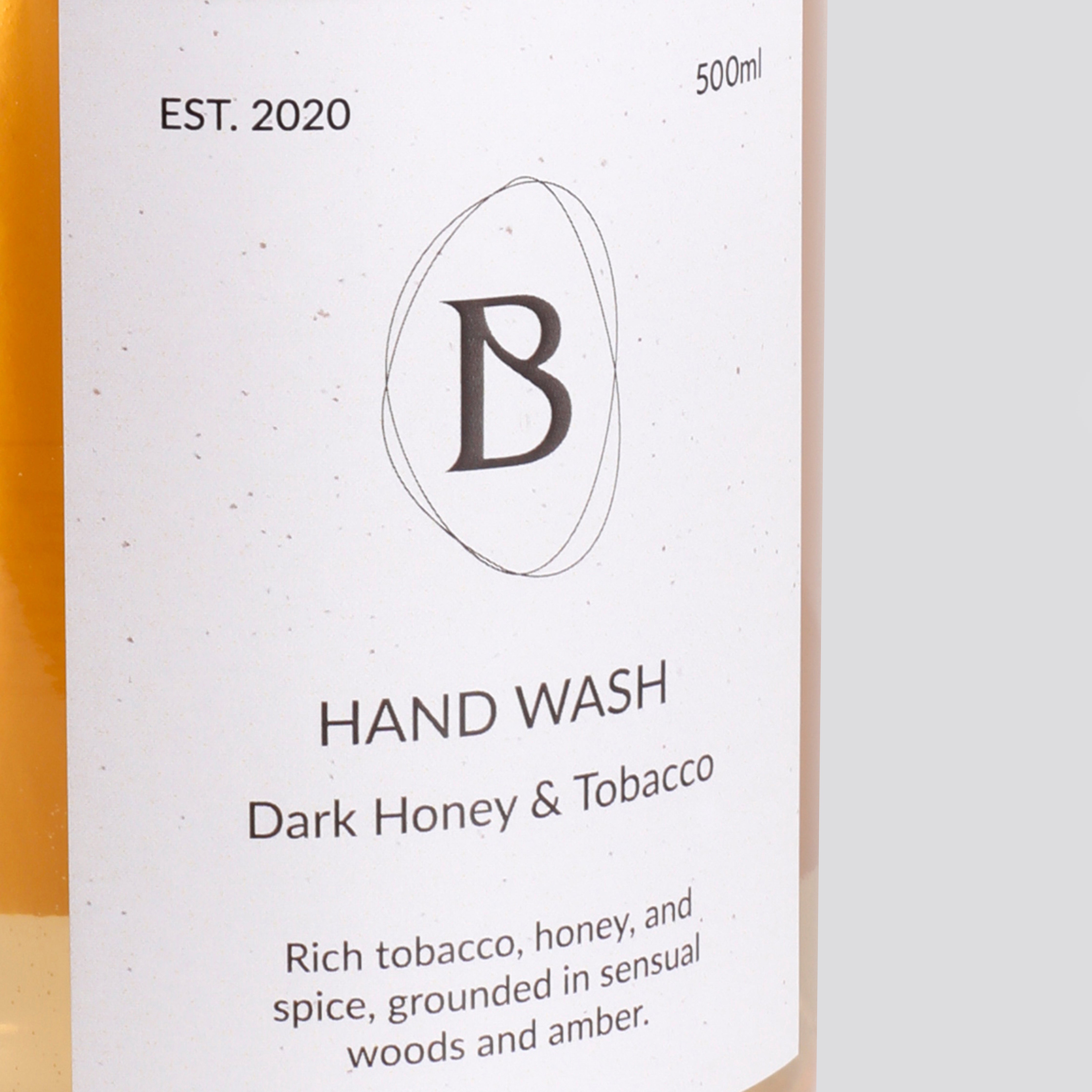 Hand wash bottle label with brand logo and product description on a white background