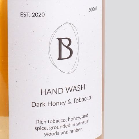 Hand wash bottle label with brand logo and product description on a white background