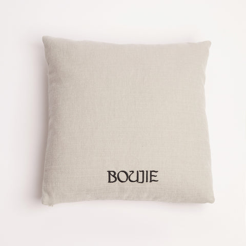 Back view of neutral linen cushion with black Boujie logo embroidery.