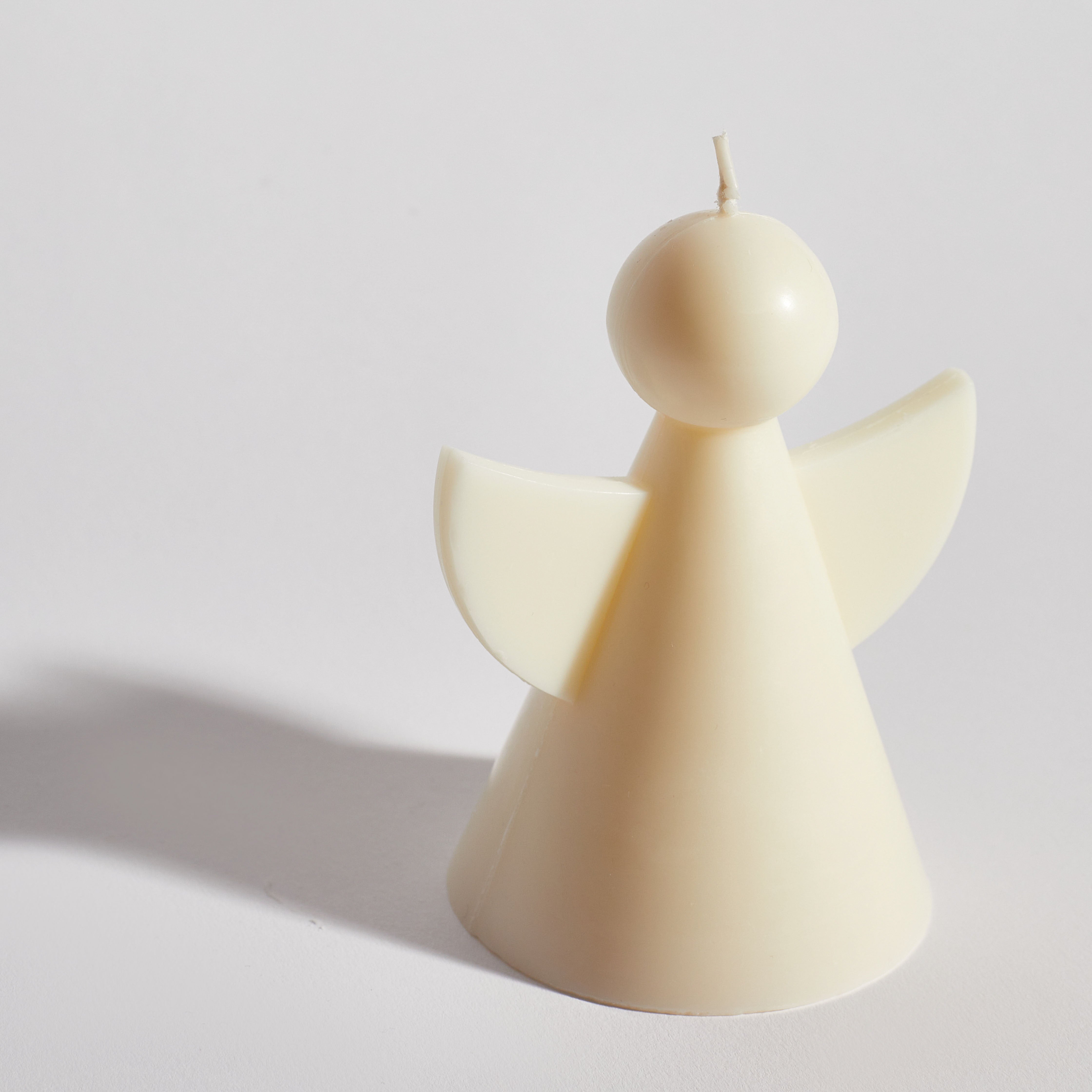 Handmade angel-shaped soy wax candle — elegant neutral home décor piece.