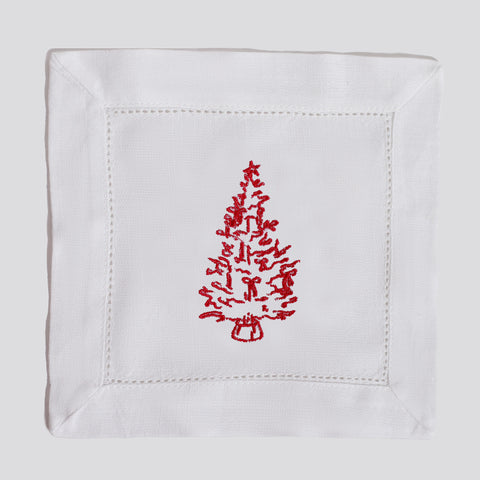 White napkin with red embroidered Christmas tree design on a white background