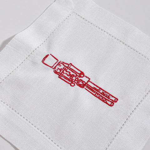 Red embroidery of a rifle on a white fabric background