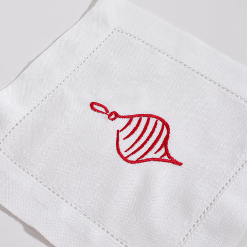 Red embroidered leaf design on a white fabric background