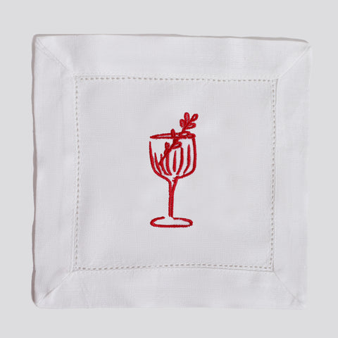White napkin with a red embroidered cocktail design on a white background
