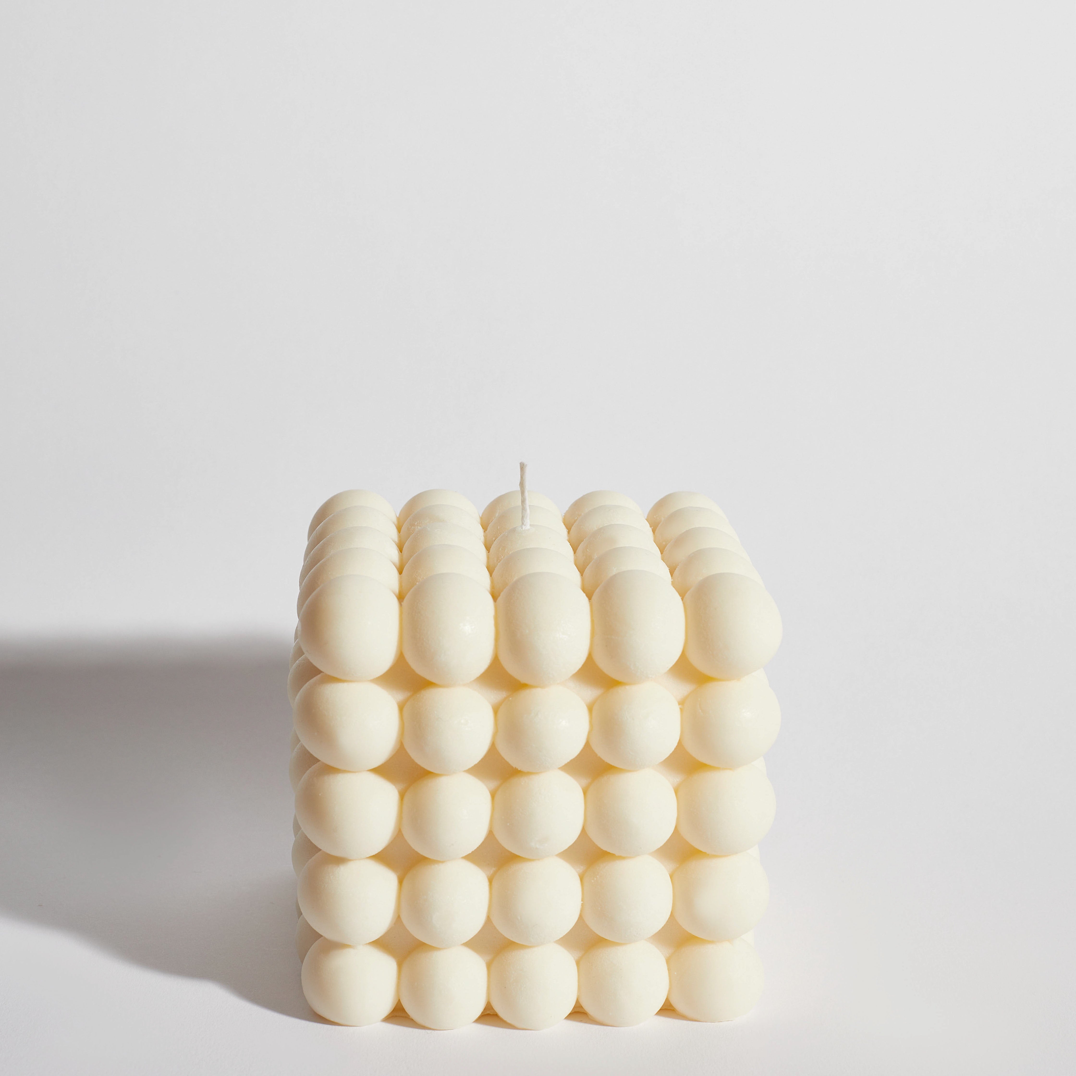 Huge bubble decorative candle front view – modern cream cube design with rounded bubble texture.