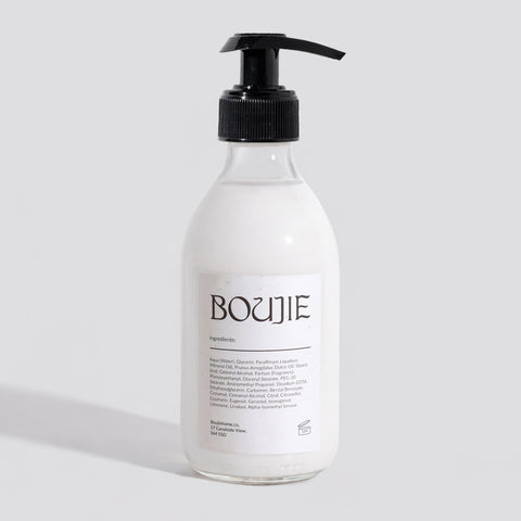 Bottle of Boujie product on a light gray background