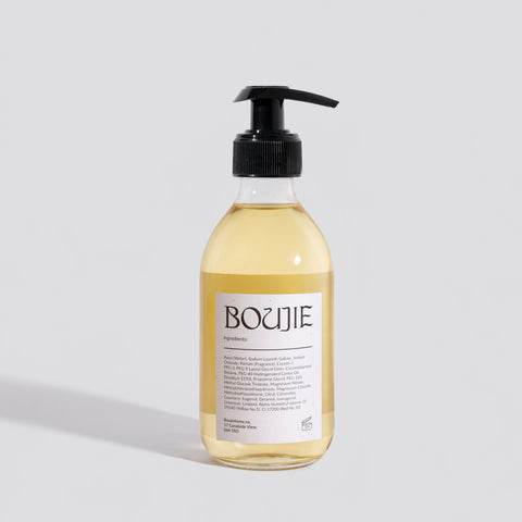Bottle of Boujie product on a light gray background