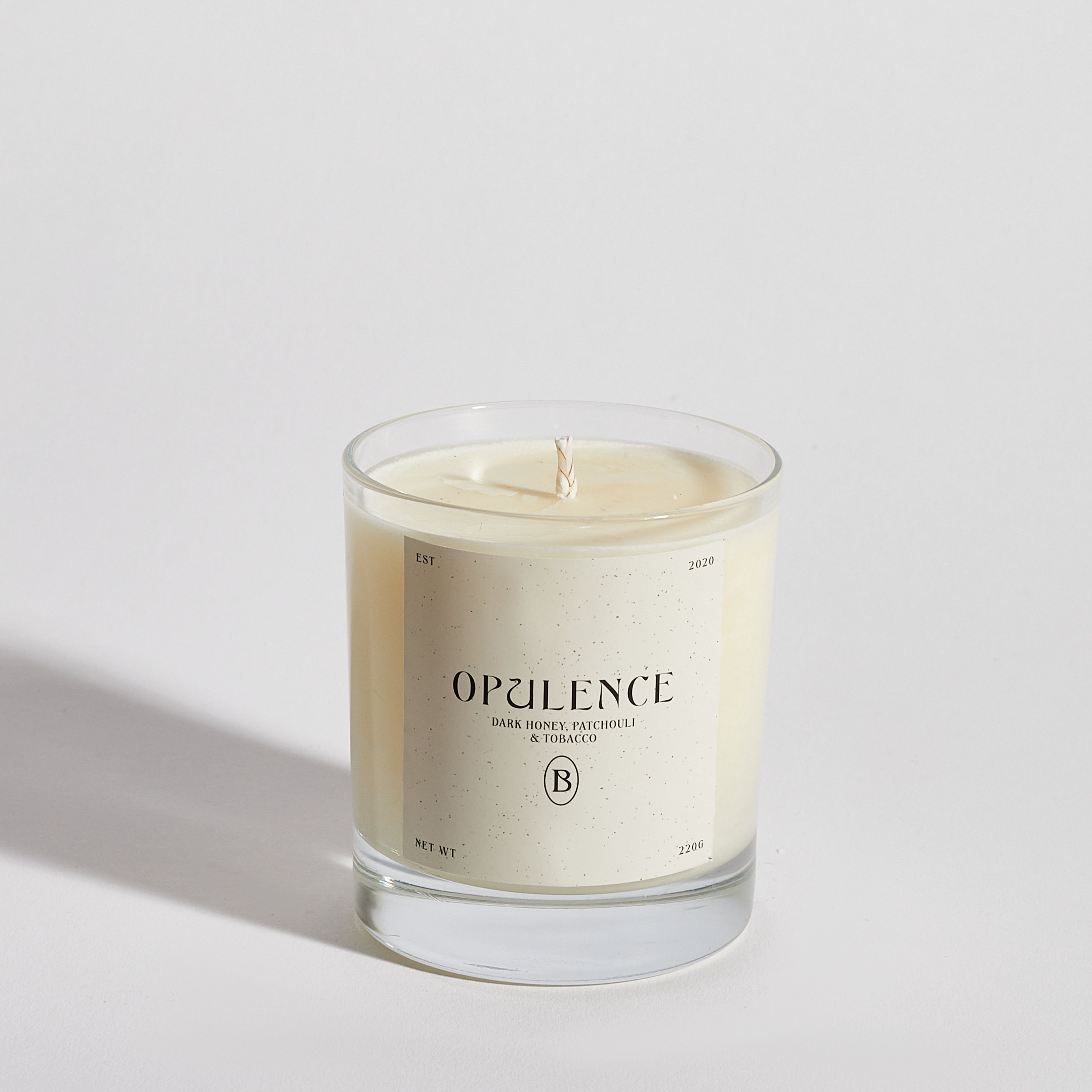 Boujie Opulence luxury soy wax jar candle, front view, handmade with natural soy wax in a clear glass jar, scented with dark honey, patchouli, and tobacco.