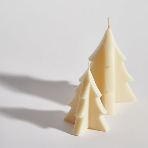 Two sculptural Christmas tree candles handcrafted from natural soy wax.