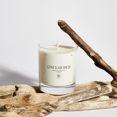 Boujie Unclouded Scented Jar Candle with driftwood and ocean-inspired accents, front view.