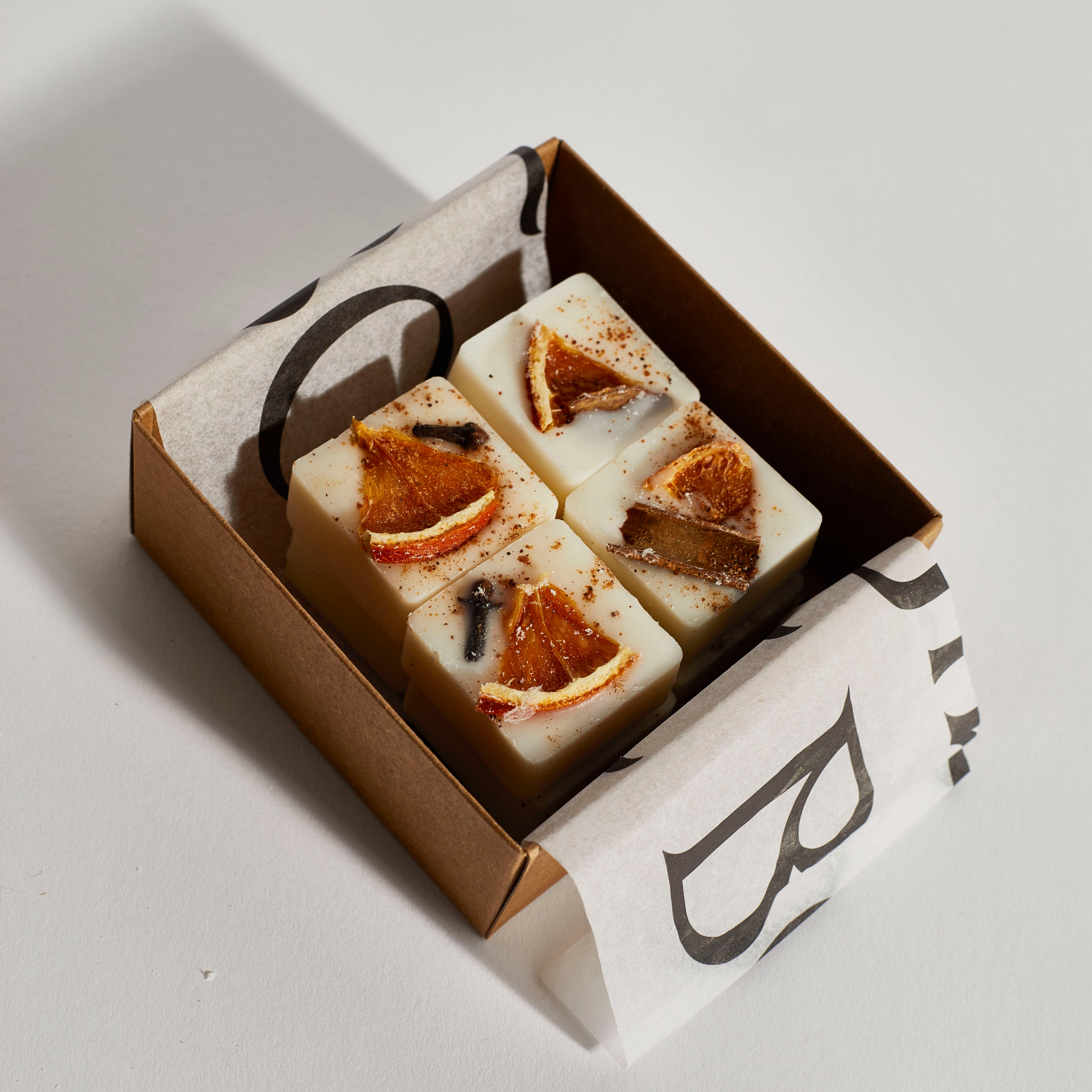 Close-up of eco-friendly soy wax melts infused with festive botanicals.